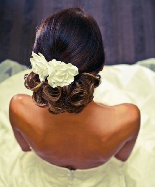 Low Updo with Flower Black Wedding Hairstyles
