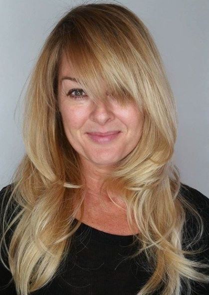 Beach Blonde Wispy Layers with High Crown- Long layered haircuts with bangs
