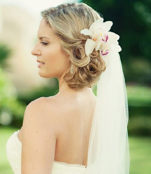 Curly Knot with a Flower beach wedding hairstyles