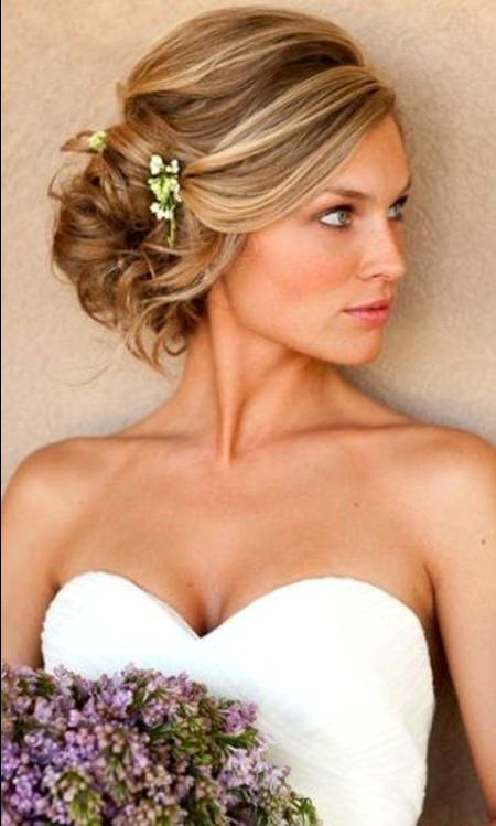 Side Messy Bun with a Flower hairstyles for brides and bridesmaids