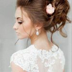 Beautiful Messy Bun with Flower beach wedding hairstyles