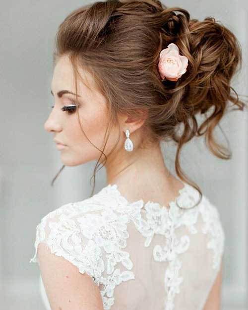 Beautiful Messy Bun with Flower beach wedding hairstyles 
