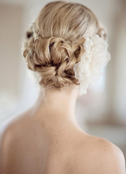 Textured Bun with a Flower- Wedding curly hairstyles